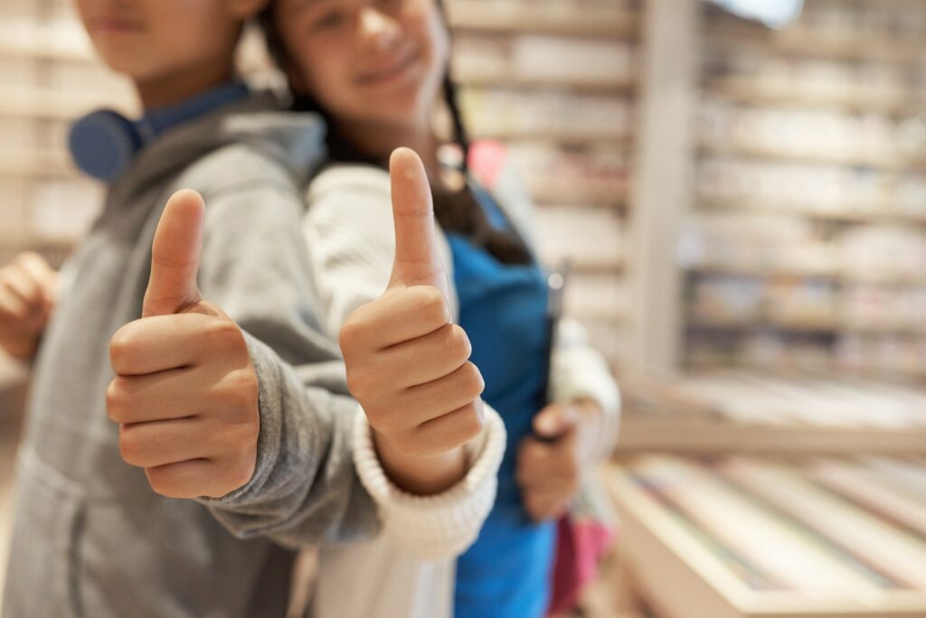 School kids giving thumbs up